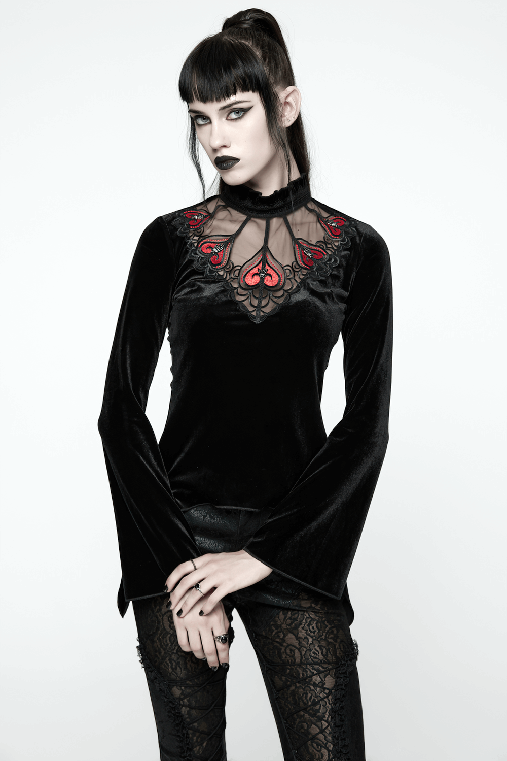 Gothic Black Velvet Top with Lace and Red Heart Detail worn by model, showcasing a striking gothic aesthetic.