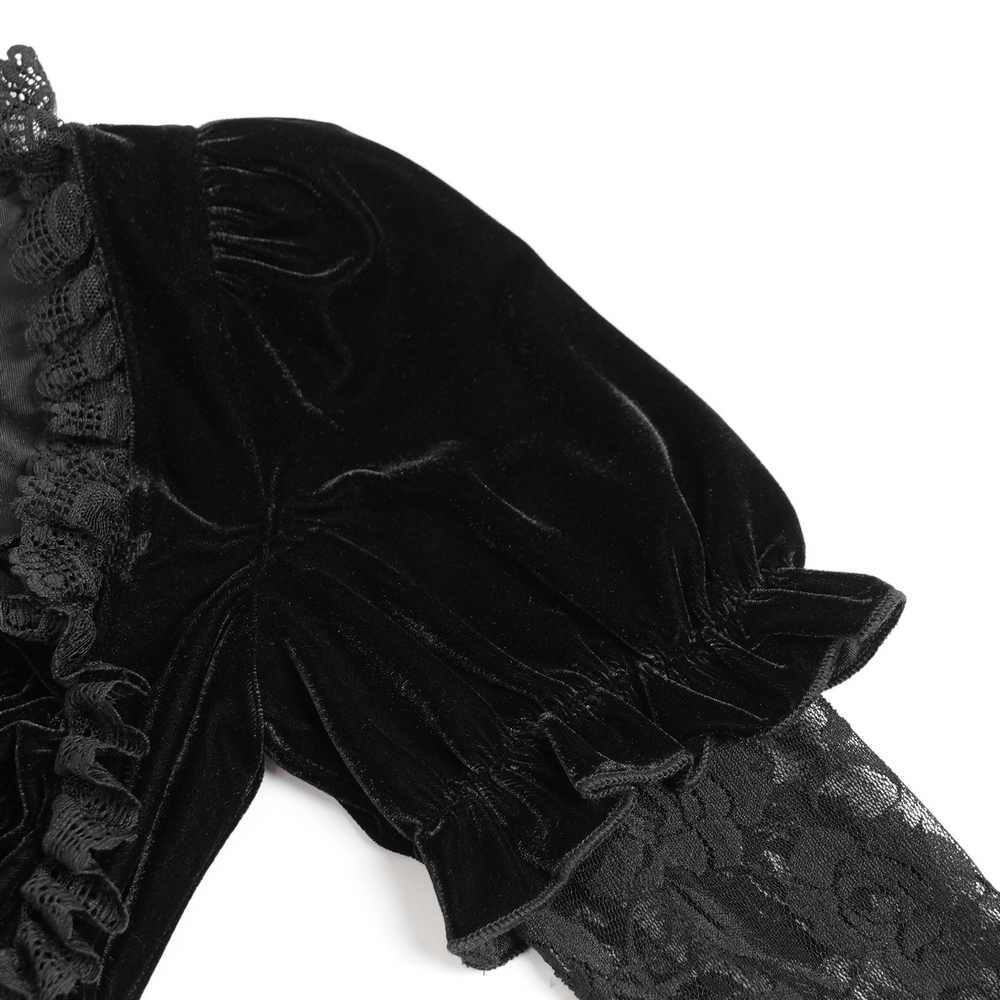 Close-up of gothic black velvet top with lace bell sleeves and ruffle trim, showcasing elegant Victorian style.