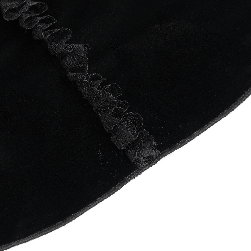 Close-up of black velvet fabric with delicate ruffle trim, showcasing gothic style elegance.