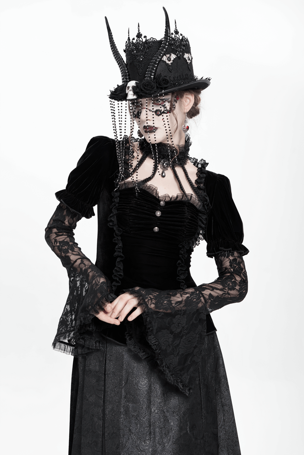 Gothic black velvet top with lace bell sleeves, styled with ornate accessories for a Victorian-inspired look.