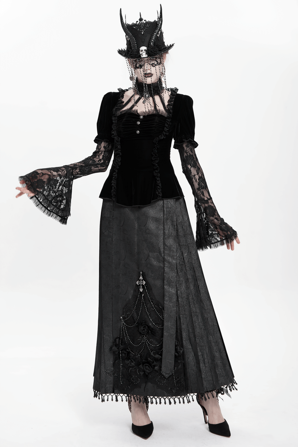 Gothic black velvet top with lace bell sleeves, paired with a dramatic skirt and stylish hat for a Victorian-inspired look.