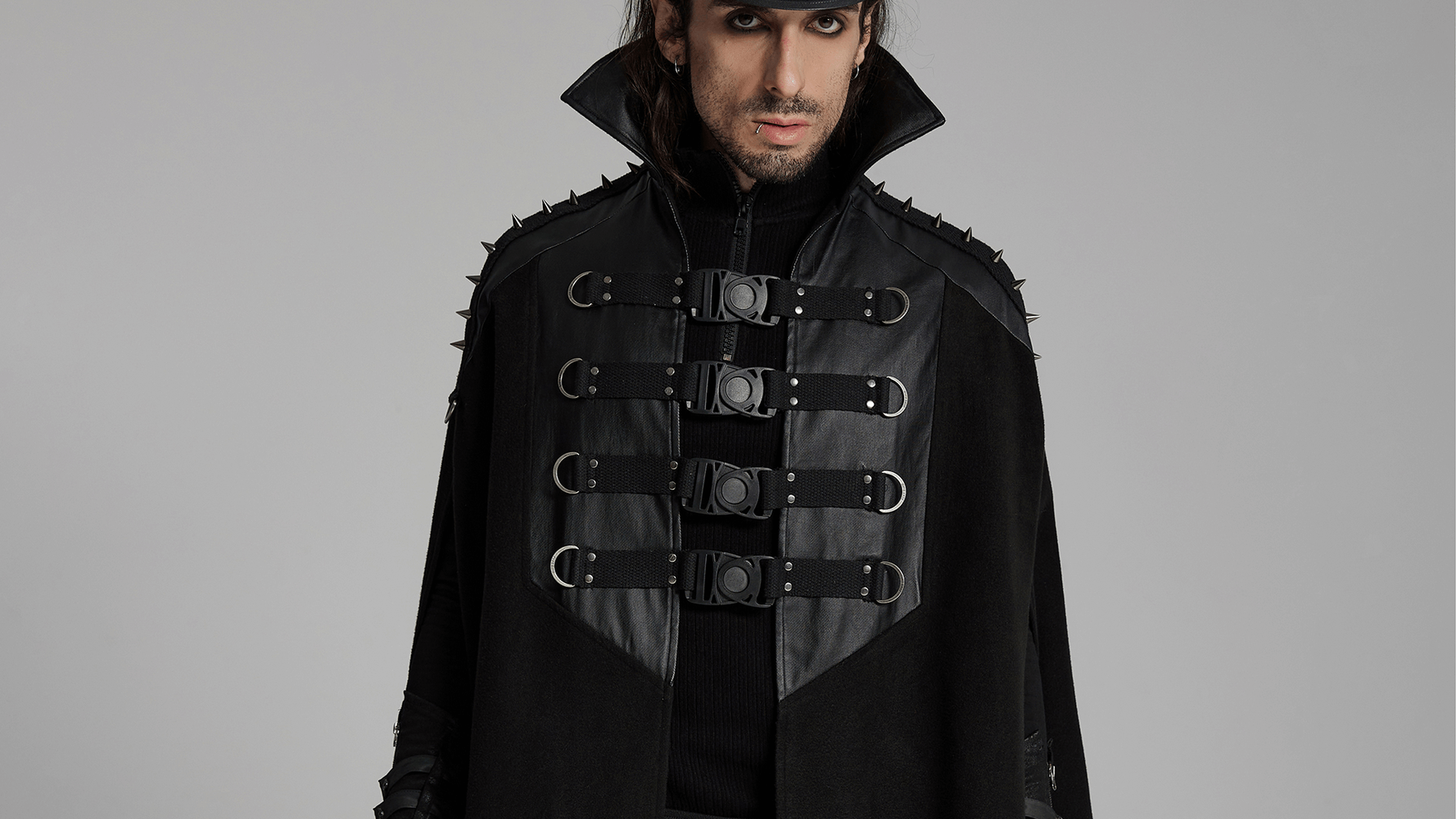 Gothic black woolen cape with bold buckles and stand collar, showcasing punk style and unique fashion statement.