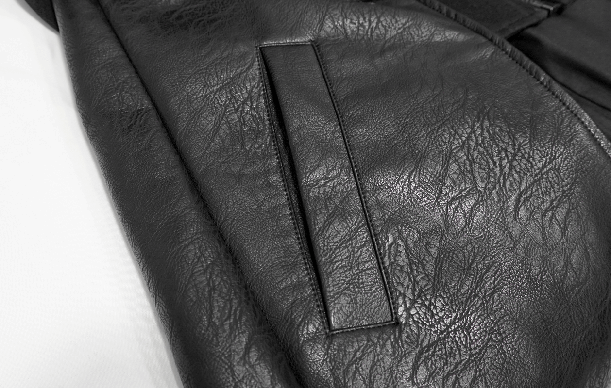 Close-up of the textured PU leather on a Gothic black men's coat, showcasing intricate details and stylish pocket.