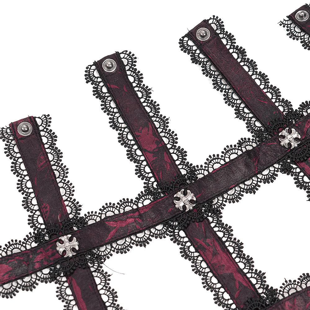 Detailed view of wine red gothic lace fabric with silver accents for corset design.