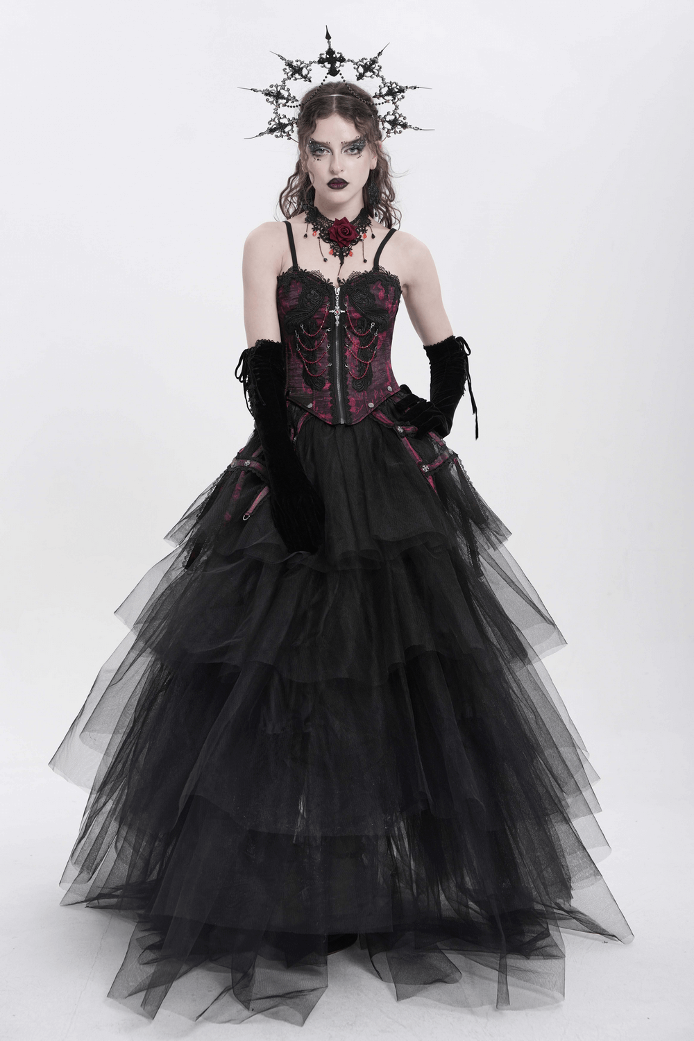 Dramatic gothic corset with layered black tulle skirt, intricate lace, and bold accessories for a striking look.