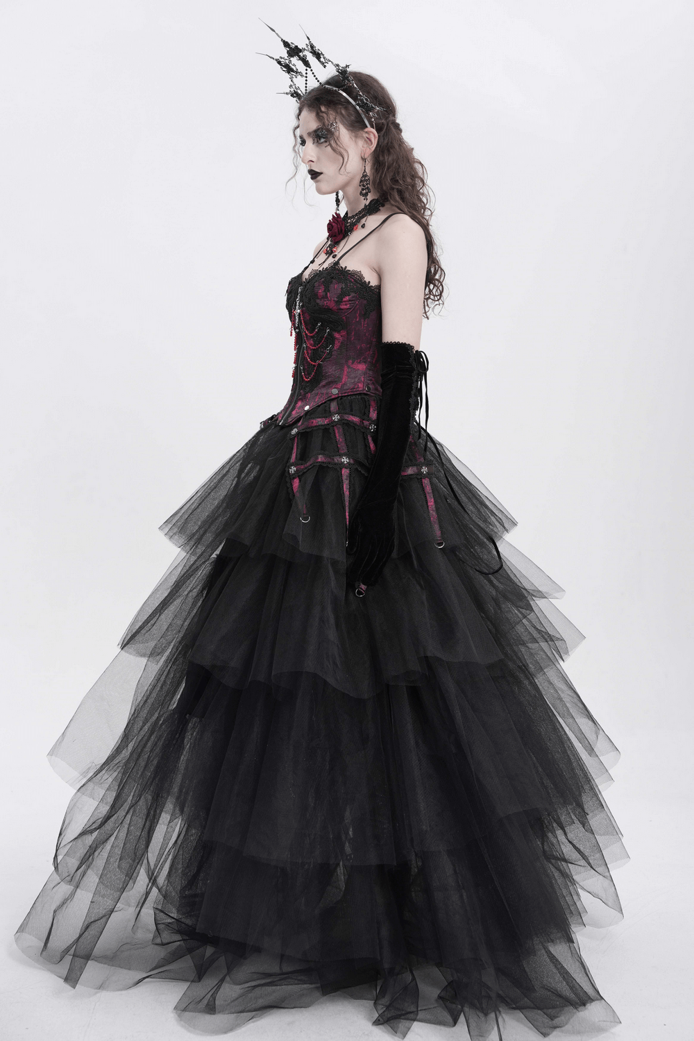 Elegant black gothic gown with layered tulle and wine red corset, accented by a dramatic crown and gloves.