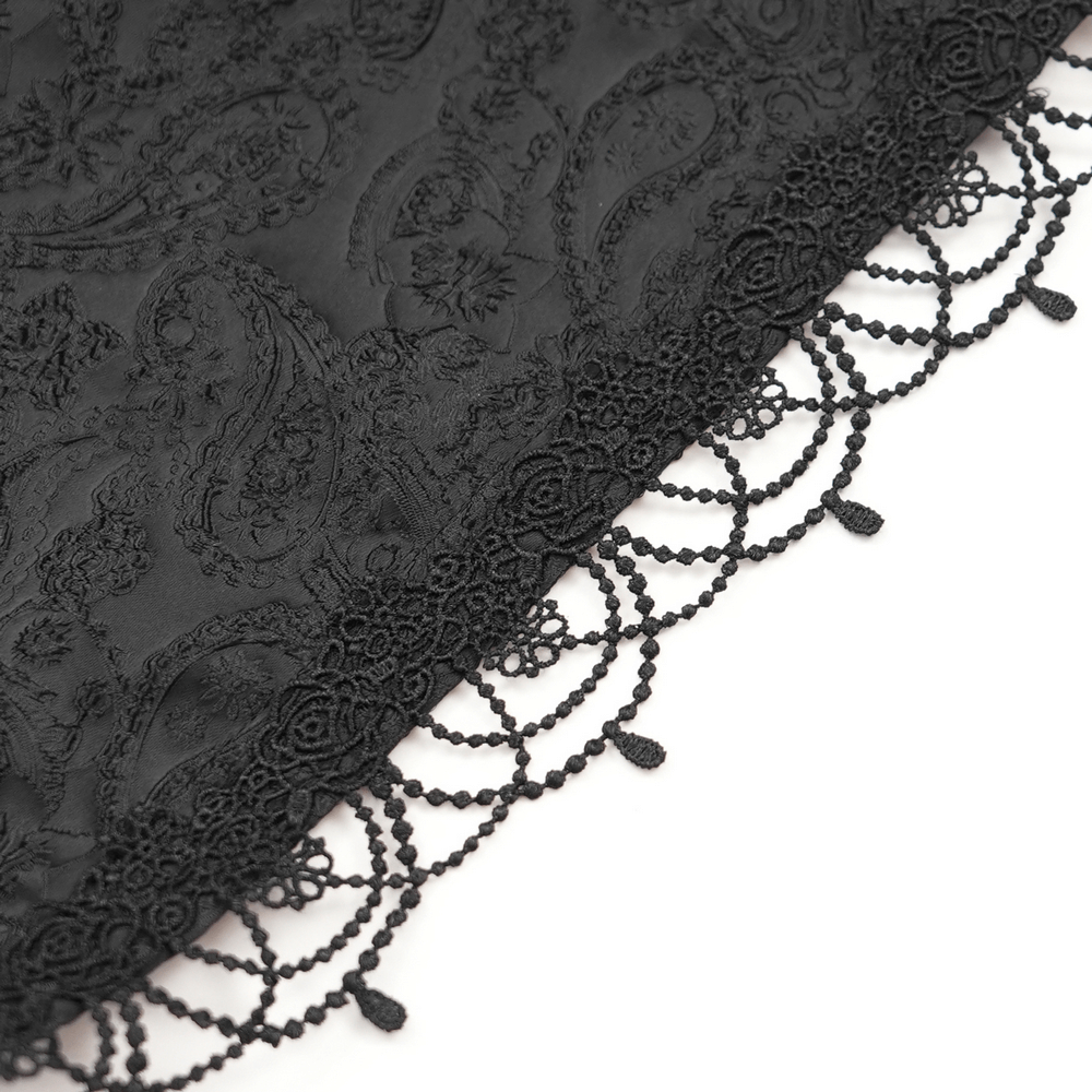 Intricate black lace trim with delicate beaded detailing on gothic brocade fabric.