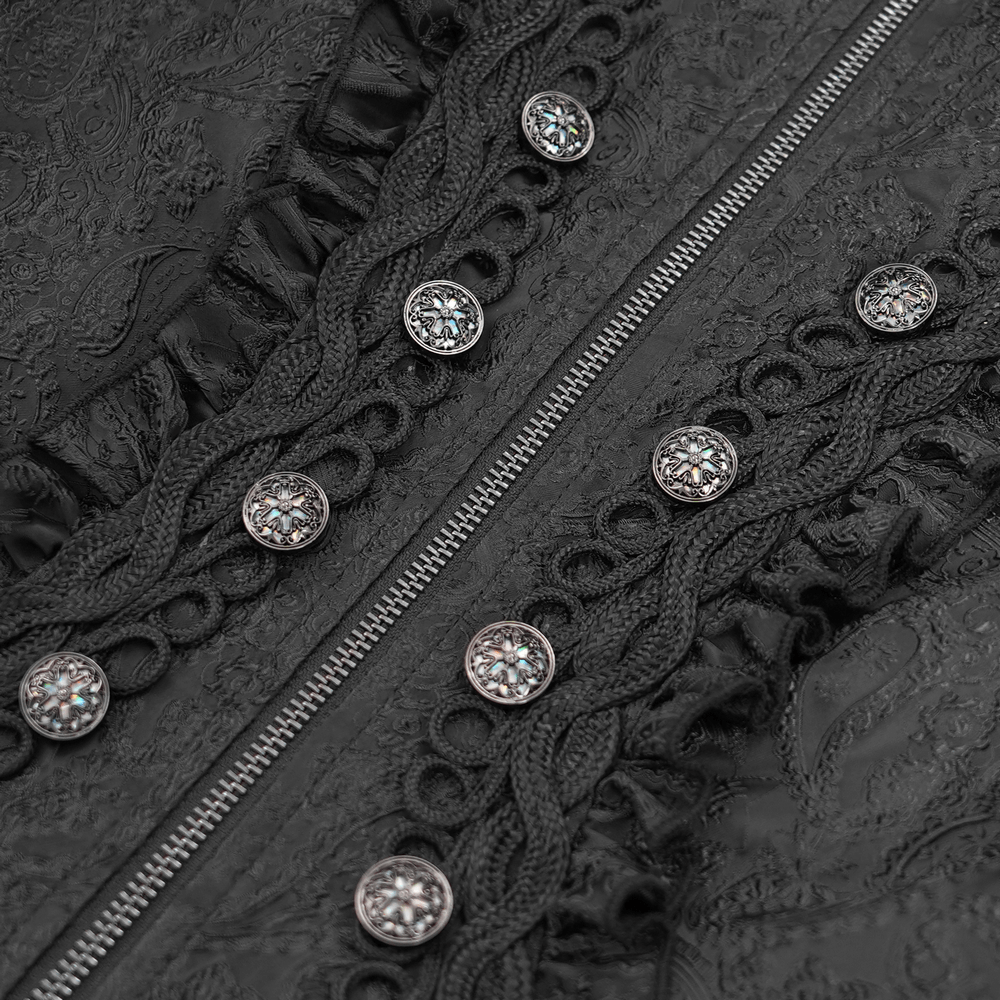 Close-up of gothic black brocade fabric with intricate lace trim and ornate buttons on a hooded coat.