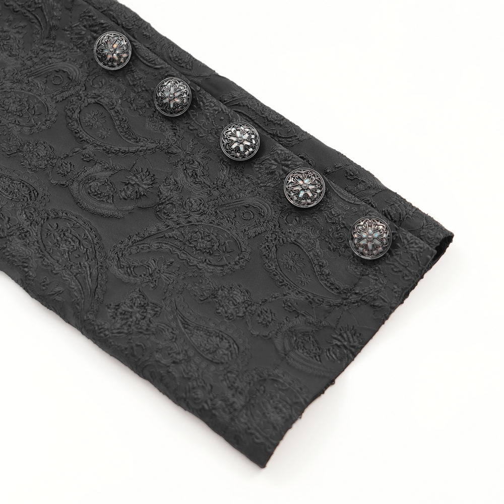 Close-up of gothic brocade fabric with ornate buttons, showcasing intricate detailing for a Victorian-inspired coat.
