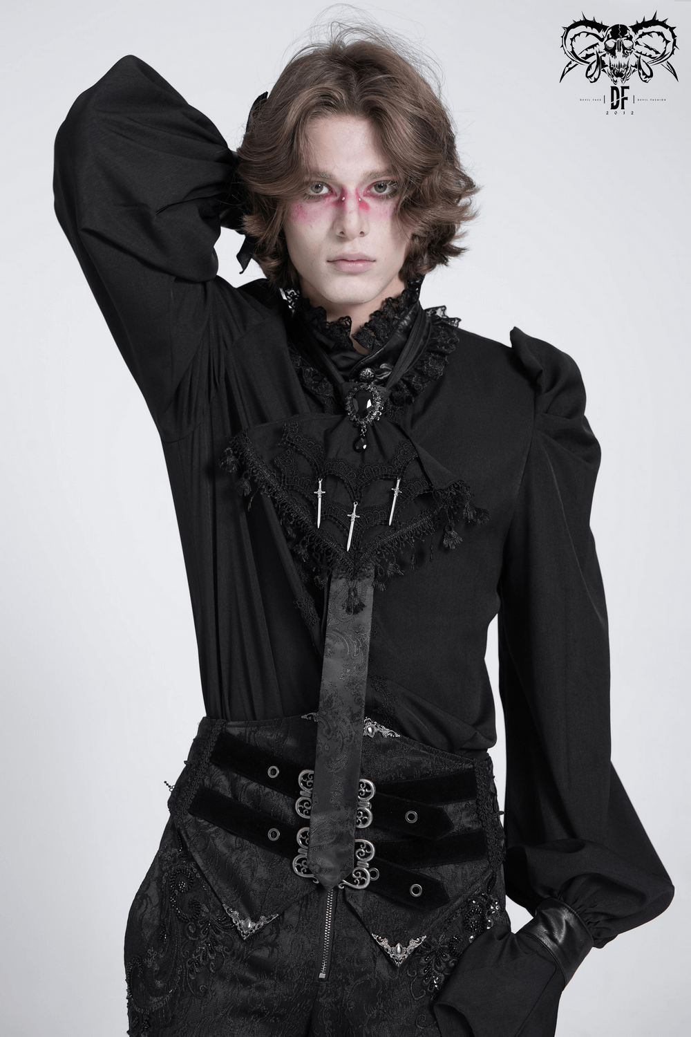 Model showcasing a gothic brocade necktie with daggers, lace, and tassel trim, perfect for dark fashion styles.