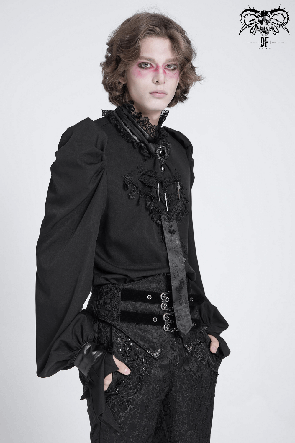 Model showcasing gothic fashion with dramatic sleeves and intricate lace detailing, embodying dark elegance.