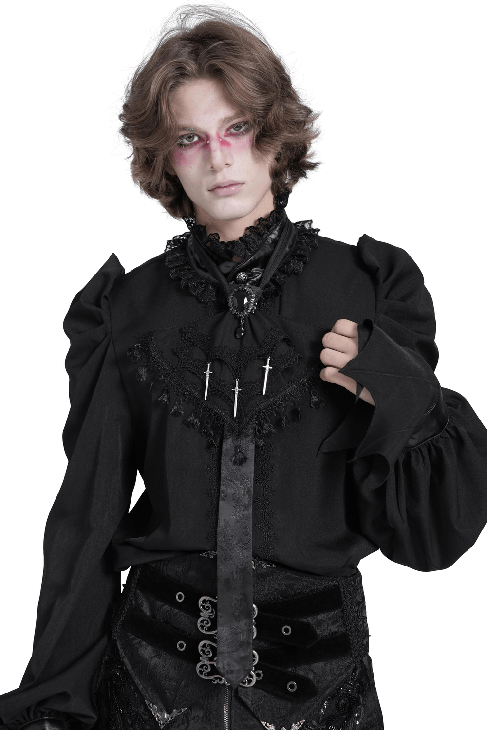Gothic fashion model wearing a black brocade necktie and dramatic blouse with cross details and flowing sleeves.