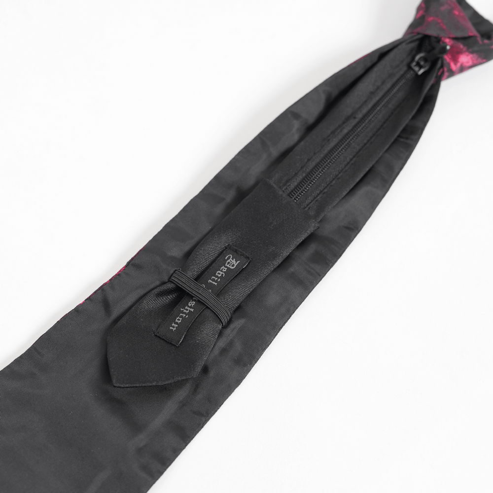 Close-up of gothic brocade necktie with zipper closure, featuring intricate black and pink design.