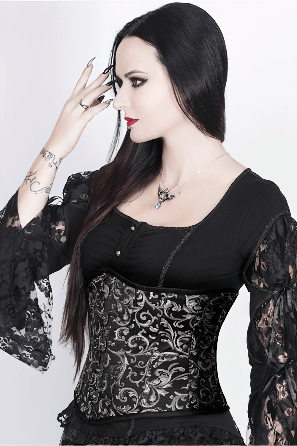 Gothic brocade underbust corset with skull busk, styled for waist training and dark elegance.