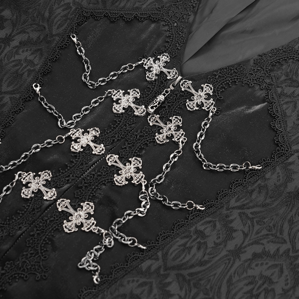 Intricate silver chains with cross details on a black brocade fabric, perfect for a gothic or Victorian-inspired look.