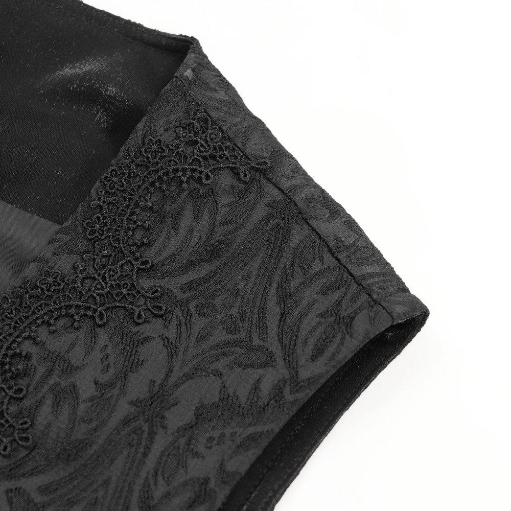 Close-up of gothic brocade waistcoat showing intricate black fabric and elegant detailing. Perfect for alternative fashion enthusiasts.
