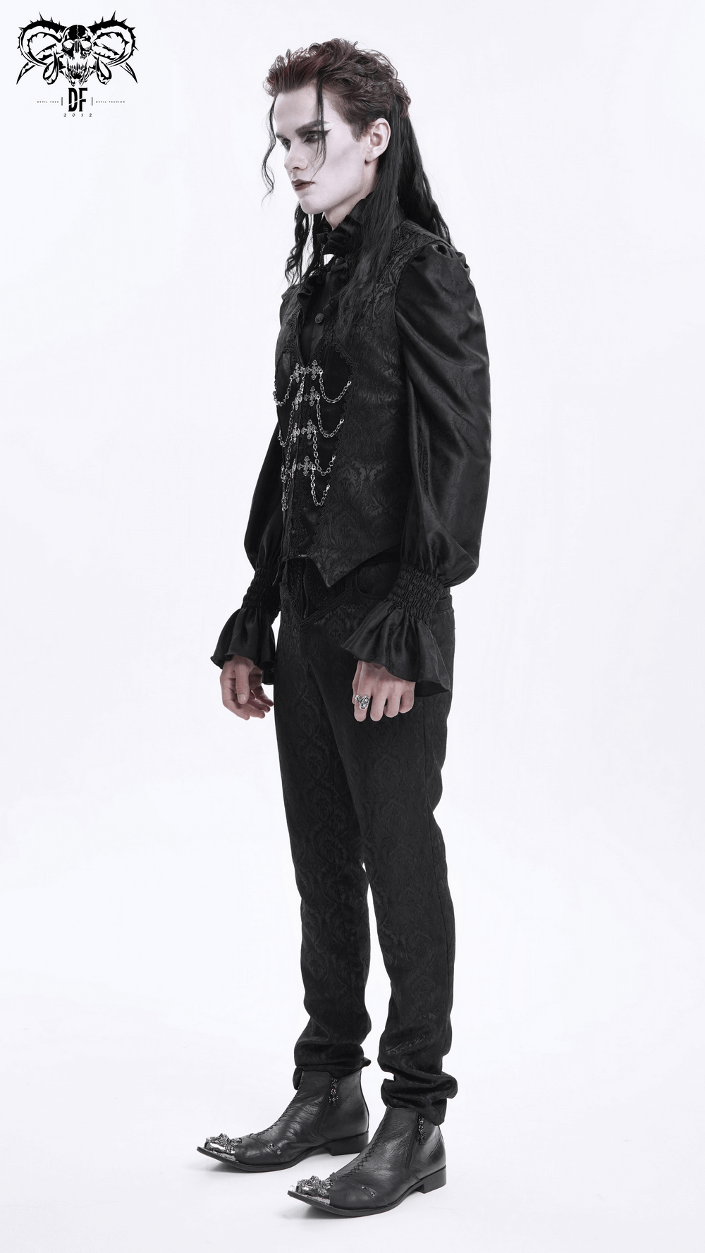 Model showcasing a gothic brocade waistcoat with chain accents and zip detail, styled for a dark, Victorian-inspired look.