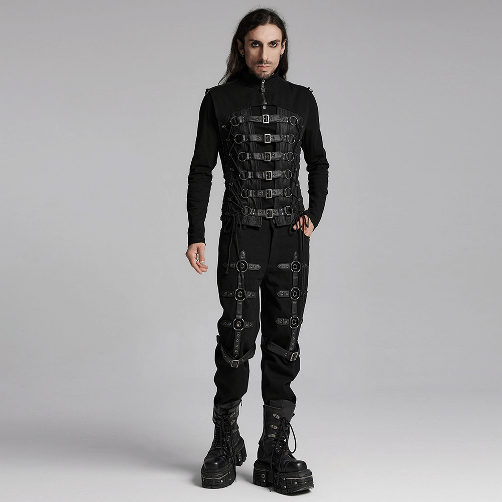 Edgy gothic vest with multiple buckles, paired with black pants and chunky boots for a striking punk look.