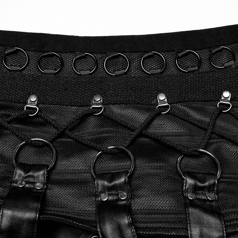 Close-up of gothic vest featuring lace-up design and metal rings for edgy punk style.