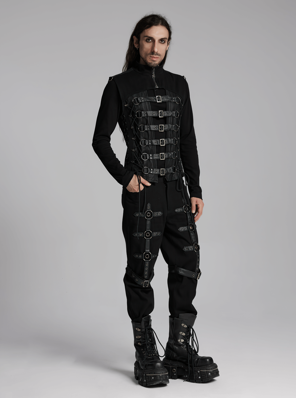 Edgy model wearing a Gothic Buckle Strap Vest with metal details, paired with sleek black pants and chunky boots.