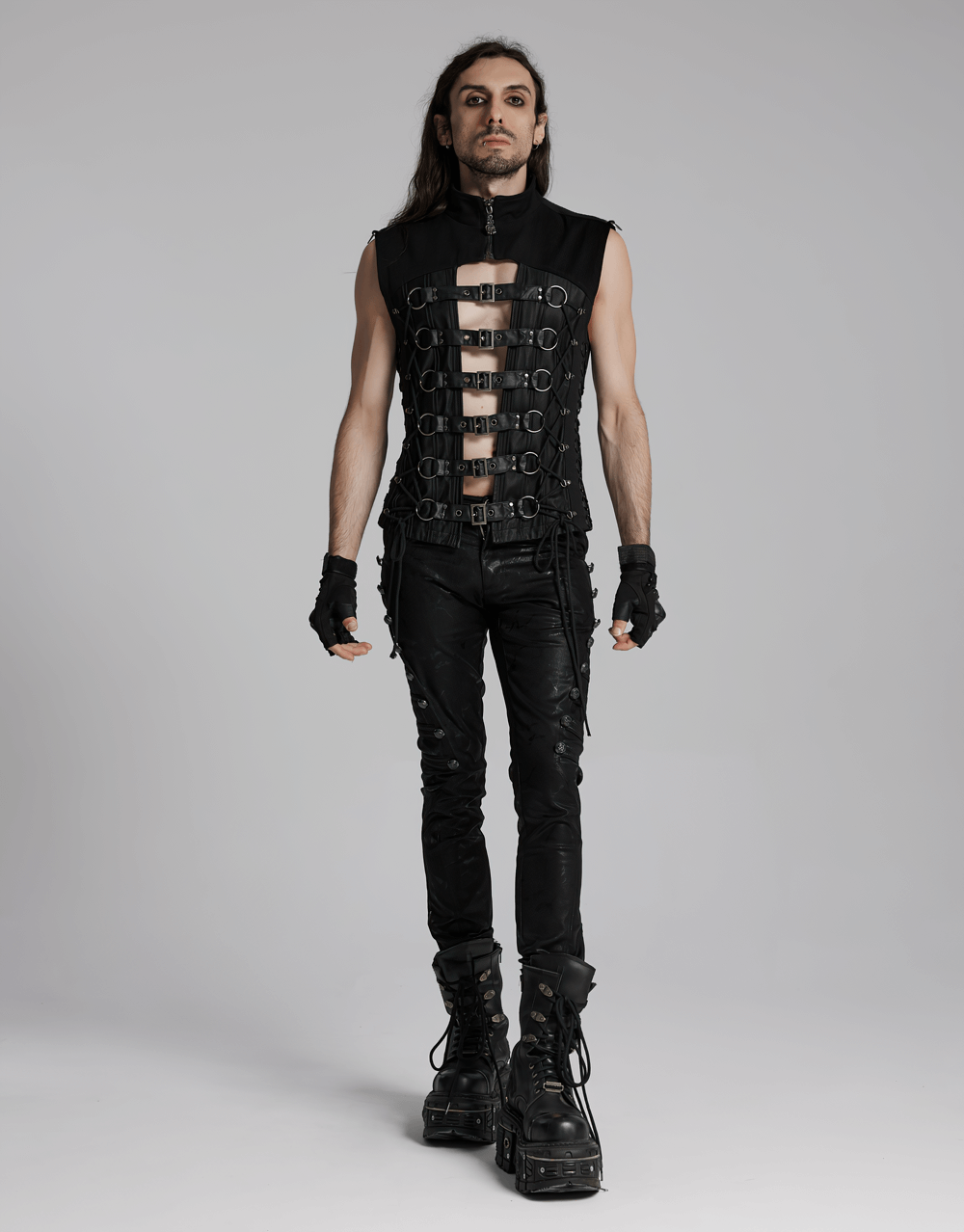 Edgy gothic vest with buckle straps, lace-up details, and punk-inspired design, paired with black skinny pants and platform boots.