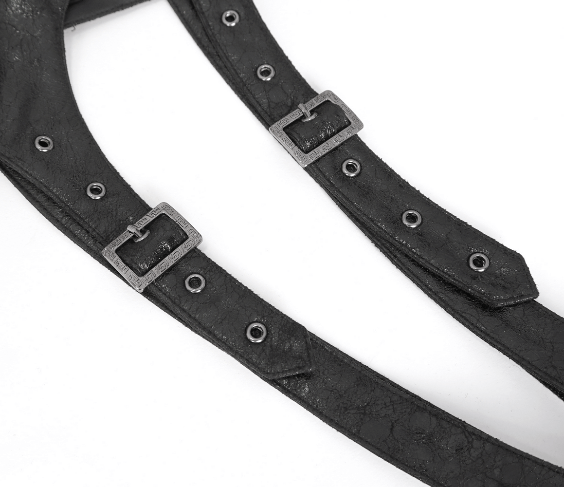 Close-up of gothic black one-shoulder harness strap with adjustable metallic buckles for urban fashion.