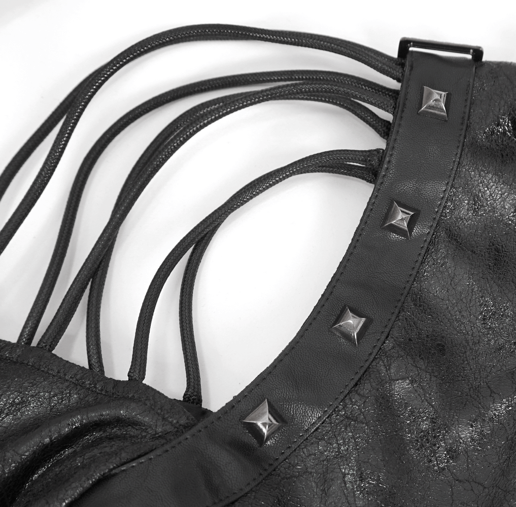 Close-up of a Gothic black one-shoulder accessory featuring sleek straps and edgy buckles for urban fashion.
