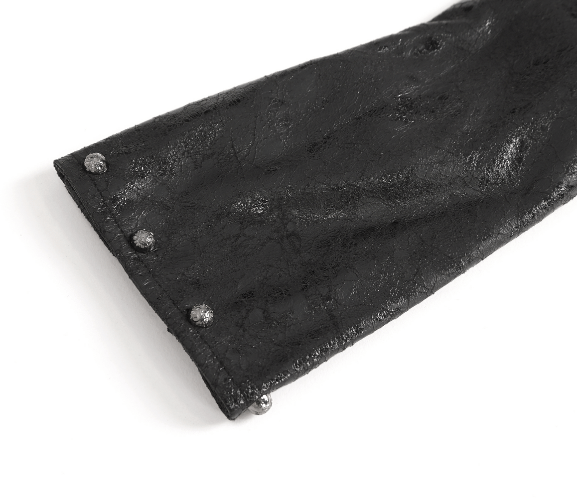 Close-up of a sleek black one-shoulder accessory with silver studs, perfect for bold urban fashion outfits.