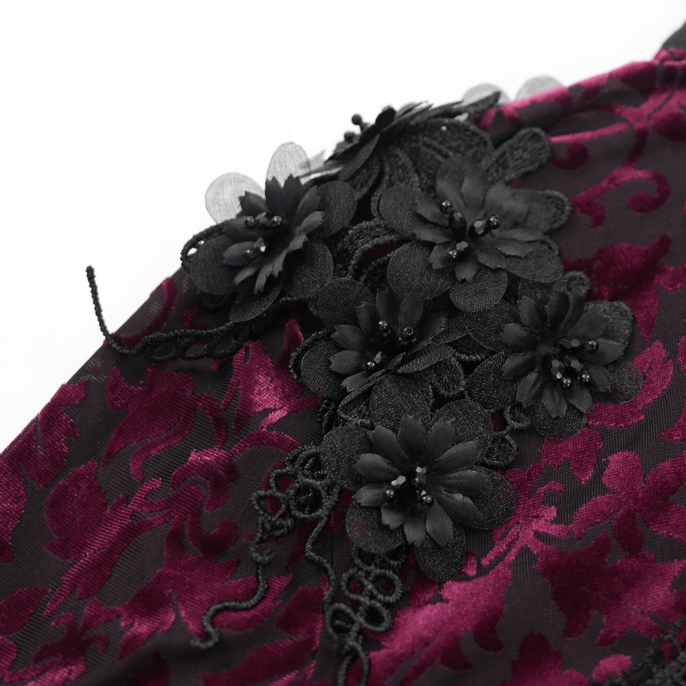 Close-up of intricate black floral lace detailing on burgundy gothic lace bolero capelet. Perfect for dark elegance.