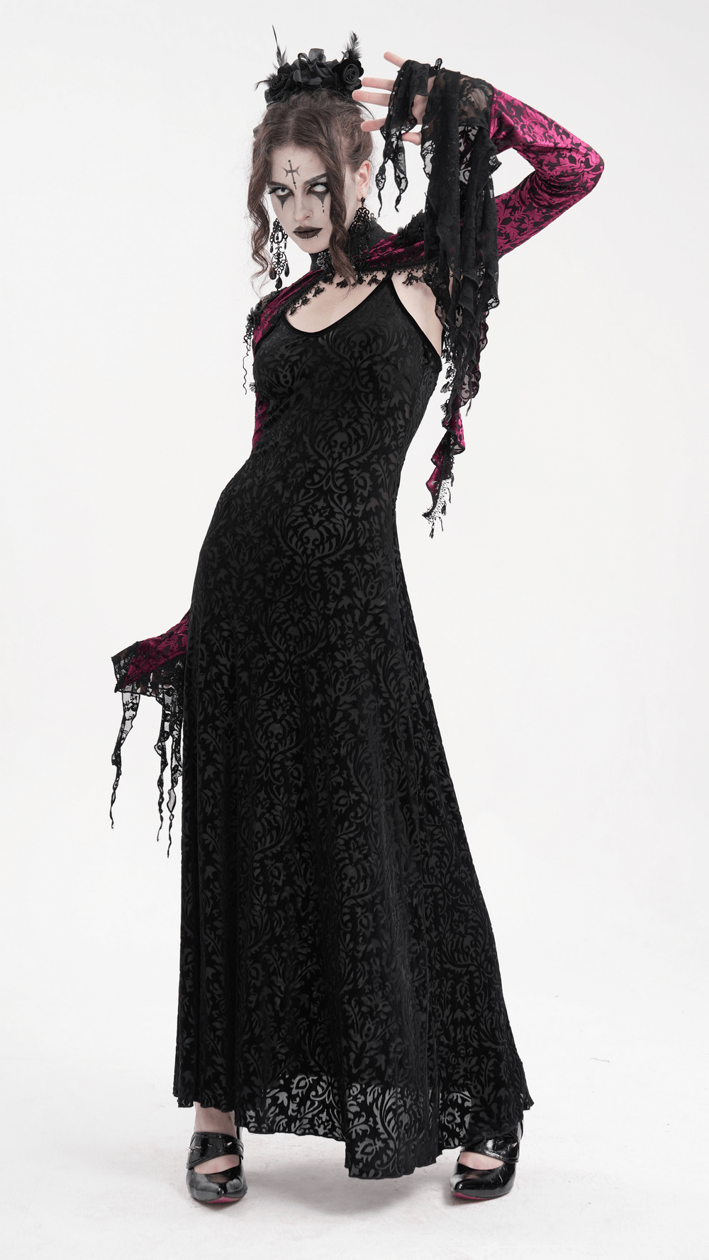 Gothic model in black lace dress with dramatic bell sleeves, showcasing dark elegance and bold goth fashion style.