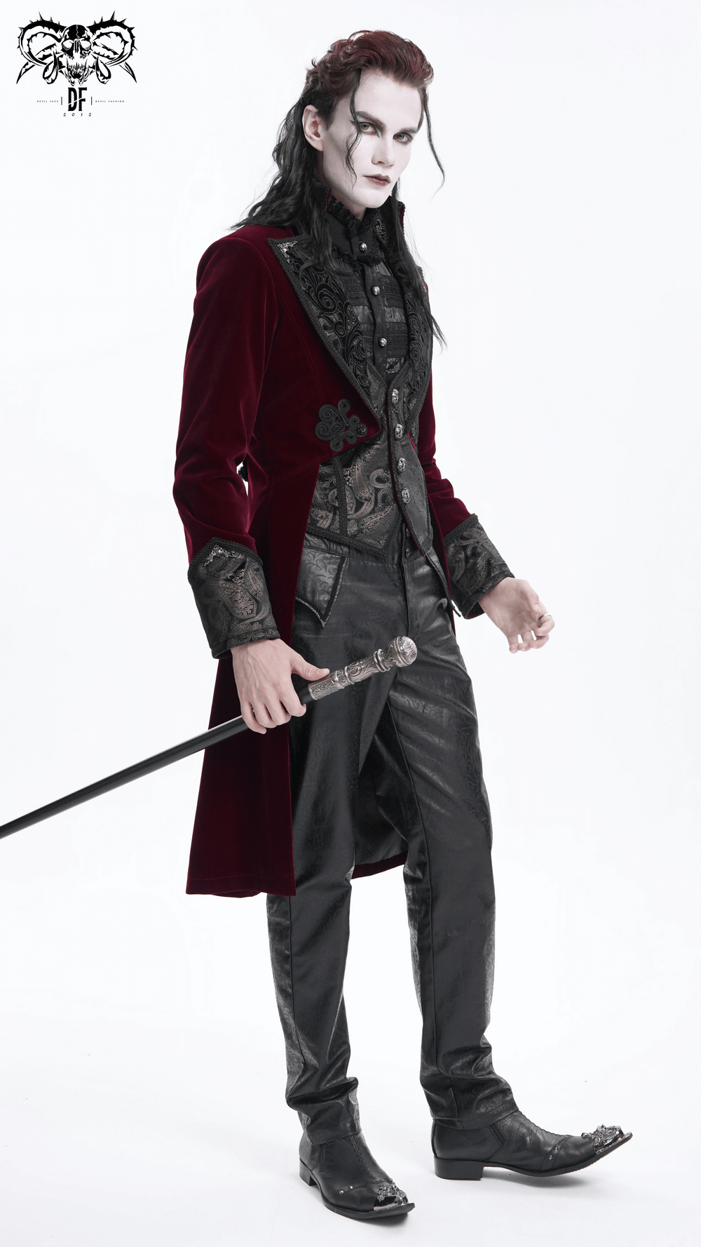 Gothic burgundy velvet tailcoat with embossed accents and gem-encrusted buttons, featuring dramatic high-low hem and structured silhouette.