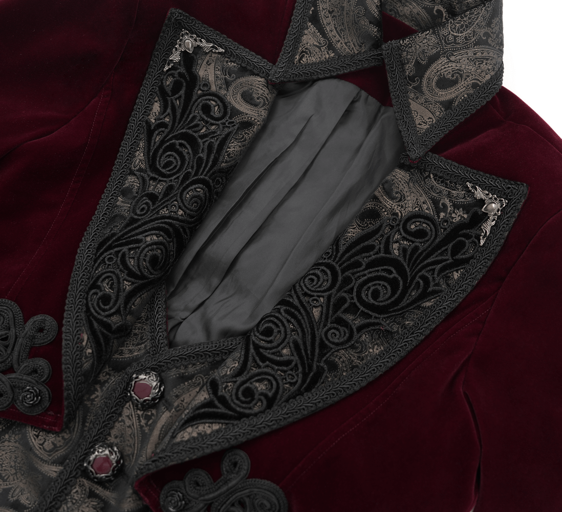 Close-up of gothic burgundy velvet tailcoat, showcasing embossed black brocade and gem-encrusted details in the collar and buttons.