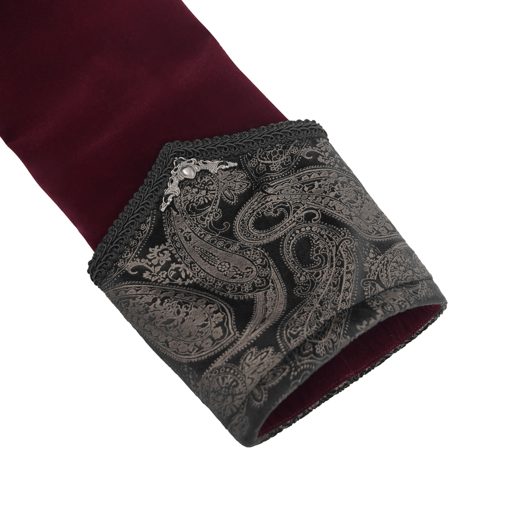 Close-up of gothic burgundy velvet tailcoat cuff with embossed black brocade detail and gem accents. Perfect for vintage elegance.