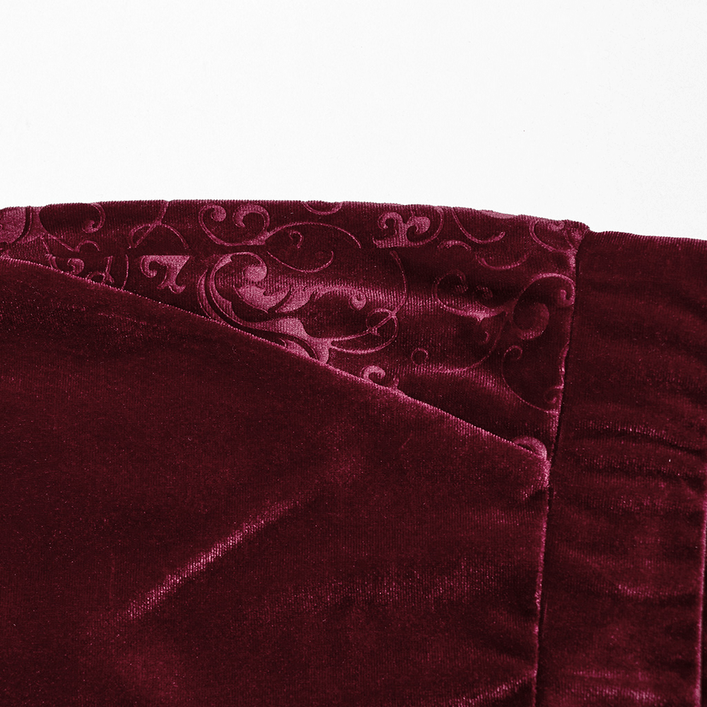 Close-up of embossed burgundy velvet fabric featuring elegant patterns for gothic fashion.