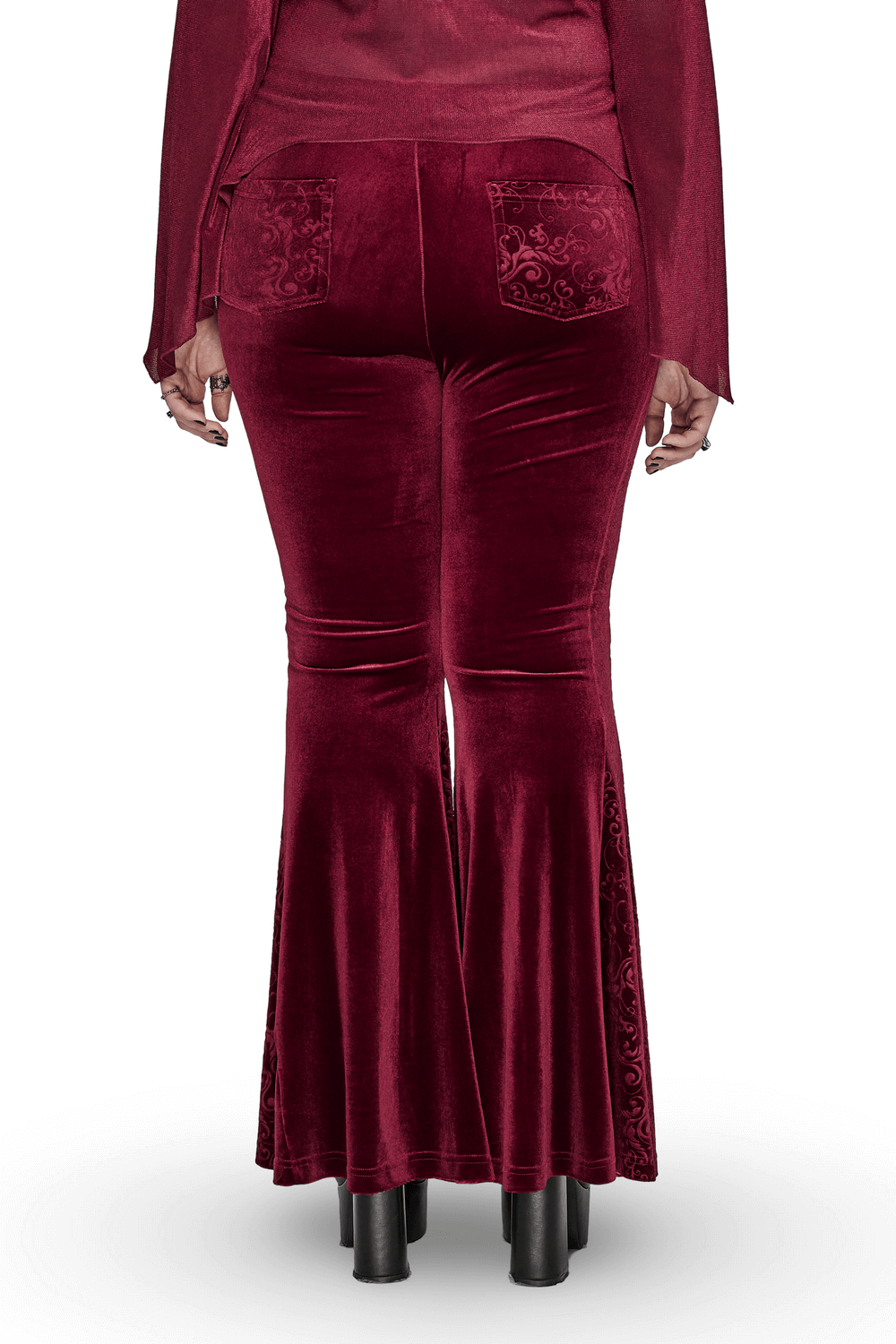 Back view of Gothic burgundy velvet flared pants showcasing embossed details and hourglass silhouette.