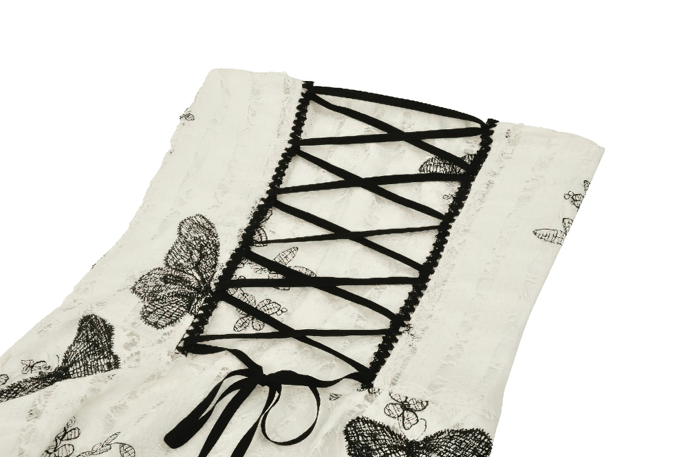 Close-up of gothic butterfly print lace-up detail on off-shoulder dress, showcasing intricate design and slits.