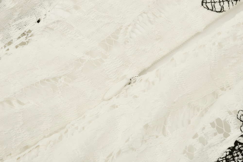 Close-up of delicate lace detailing on a Gothic-style dress showcasing intricate textures.