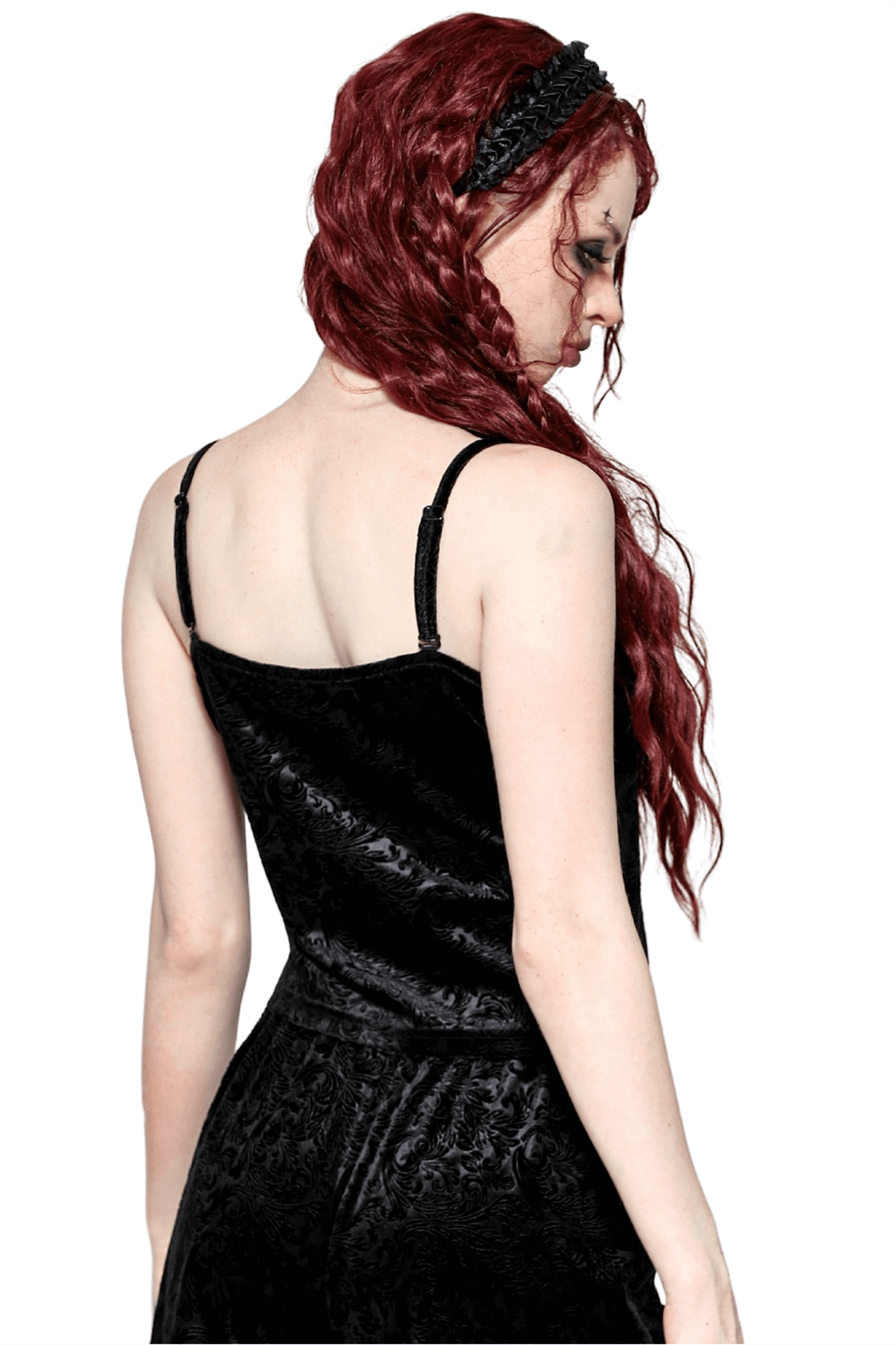 Back view of a woman in a gothic black cami with lace trim, showcasing dark romantic elegance and embossed velvet texture.