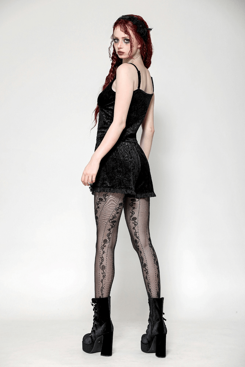 Gothic cami with lace trim and soft velvet, paired with intricate patterned tights and bold platform boots.