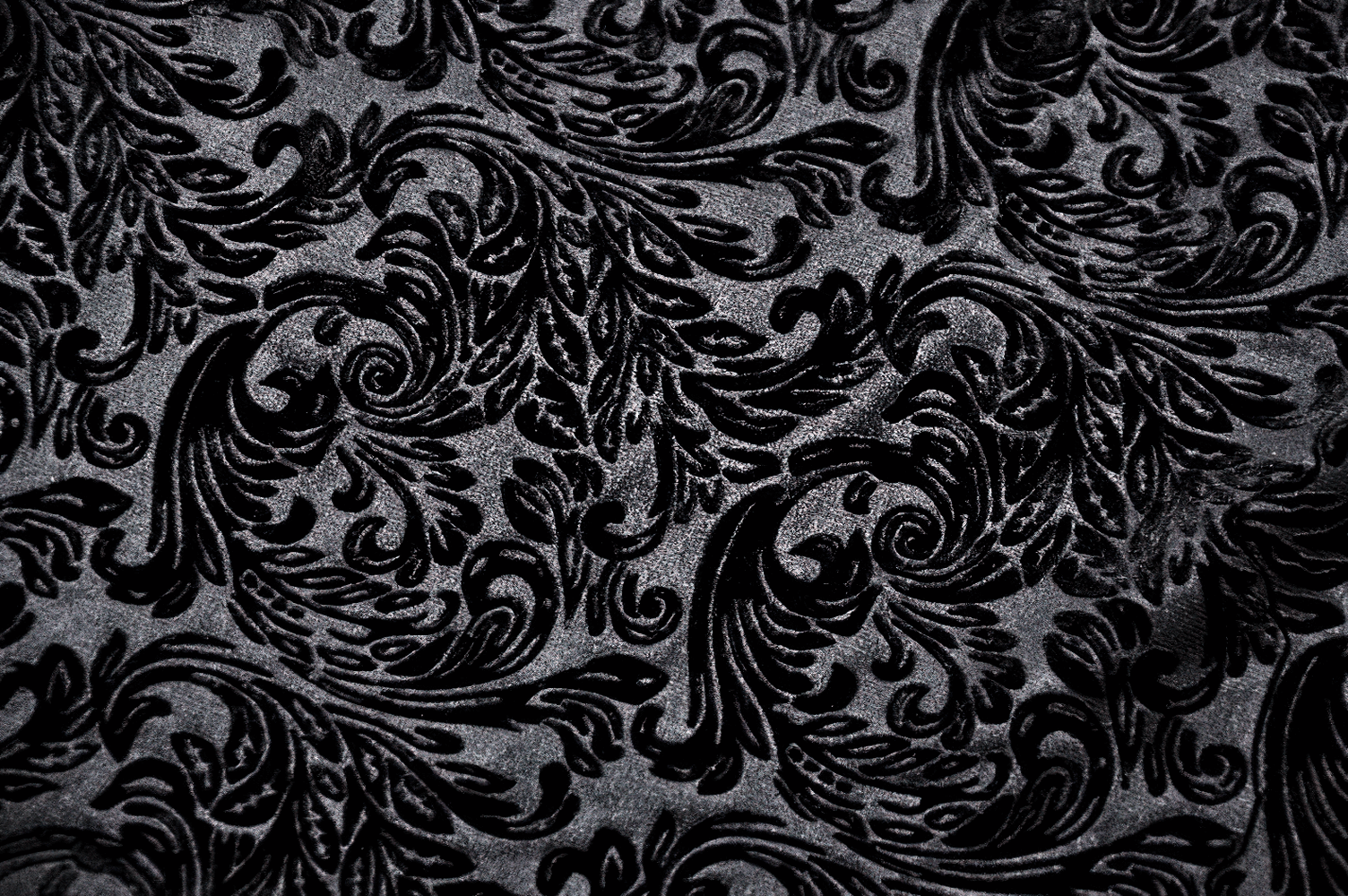 Elegant black velvet with intricate embossed floral patterns, perfect for gothic fashion and romantic aesthetics.