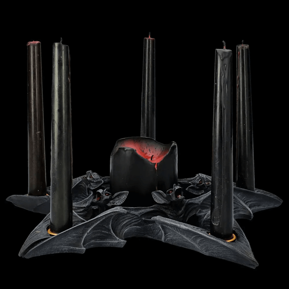 Gothic bat candle holder with black candles, perfect for Halloween decor and creating a spooky ambiance.