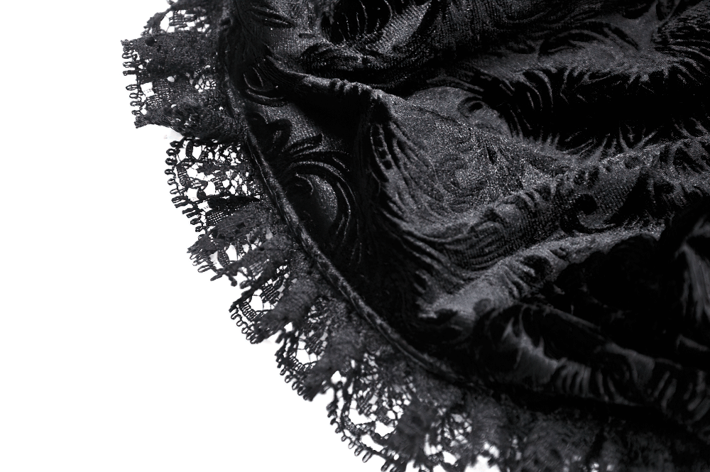 Close-up of intricate black lace with velvet trim, perfect for gothic fashion and vintage-style bonnets.