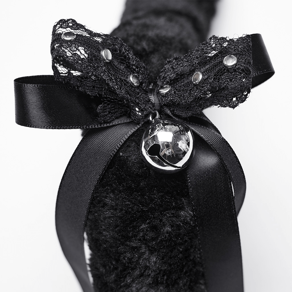 Close-up of a gothic plush cat tail with lace, rivets, and a bell, featuring decorative double bows.