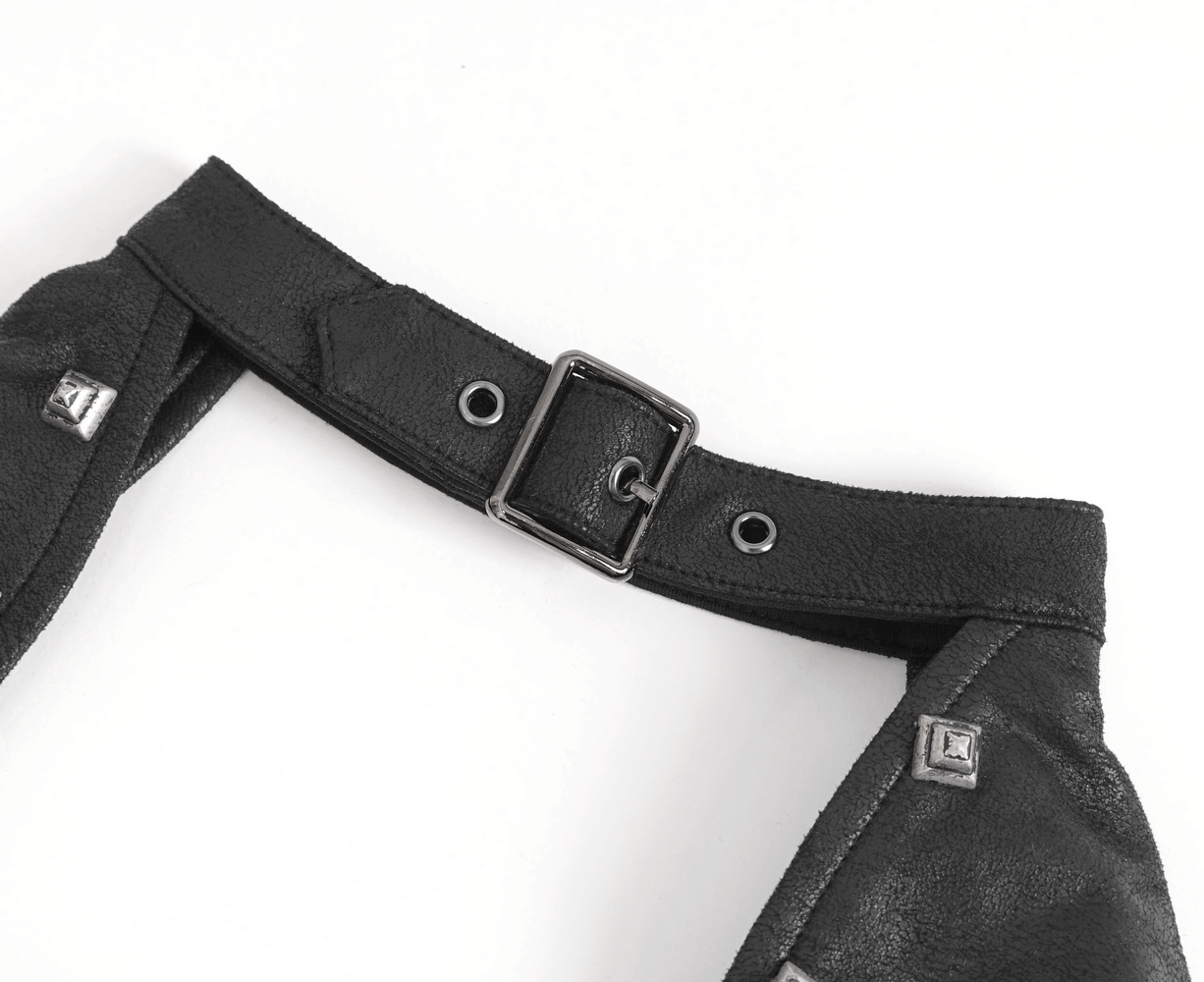 Close-up of a gothic crop top's shoulder strap with buckle and metal accents for an edgy look.