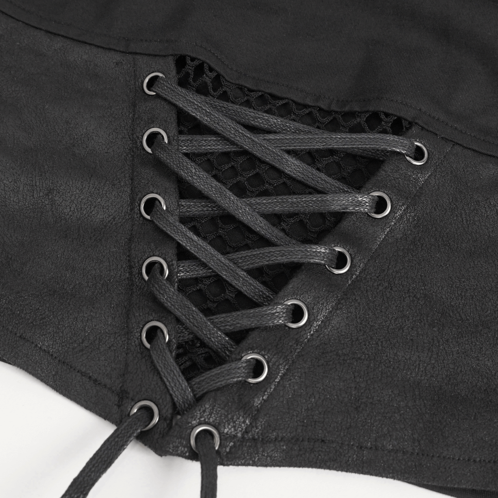 Close-up of lace-up detail on black gothic crop top showcasing edgy chain accents and mesh fabric.