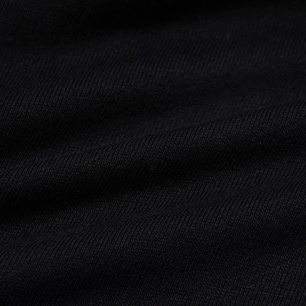 Close-up of black knitted fabric showcasing soft texture for gothic style clothing.