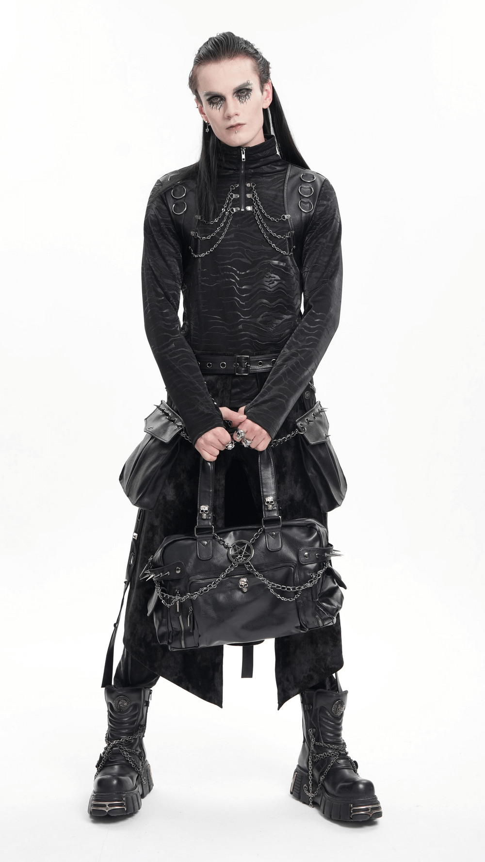 Edgy model showcasing a Gothic chain embellished black tote bag with spikes and skull accents in alternative fashion style.