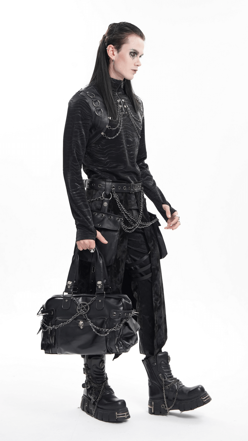 Edgy model in gothic attire showcasing a black tote bag with spikes and chains, perfect for alternative fashion lovers.