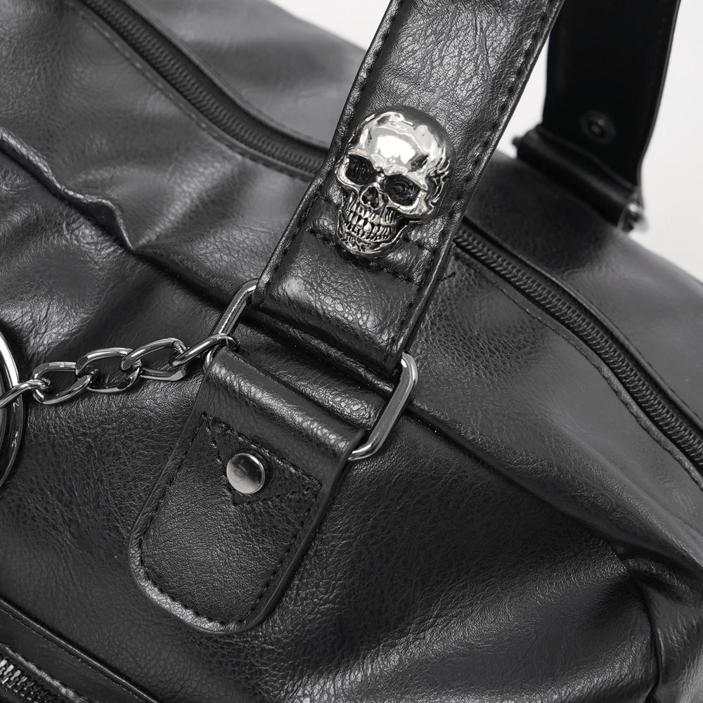 Gothic black tote bag detail featuring a skull accent and chain embellishment for edgy fashion lovers.