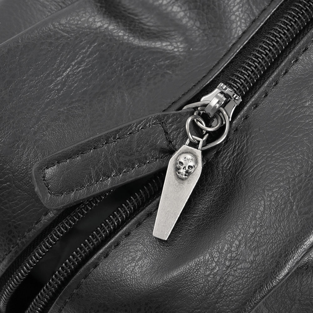 Close-up of Gothic tote bag zipper with skull coffin charm, showcasing edgy detail and durable faux leather texture.